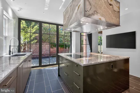 a kitchen with stainless steel appliances granite countertop a sink a stove and a microwave