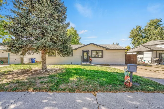 a front view of house with yard and trees