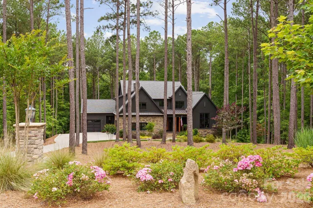 a kitchen with stainless steel appliances granite countertop a sink a stove and a wooden floors