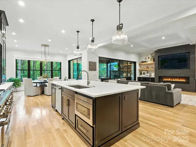 a kitchen with stainless steel appliances granite countertop a stove and a large kitchen island
