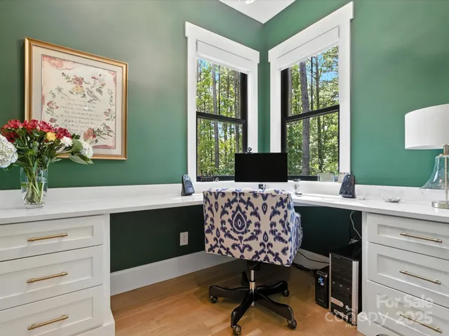 a view of a workspace with furniture and a window