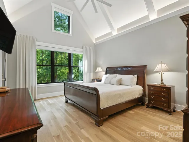 a bed room with a bed window and a television