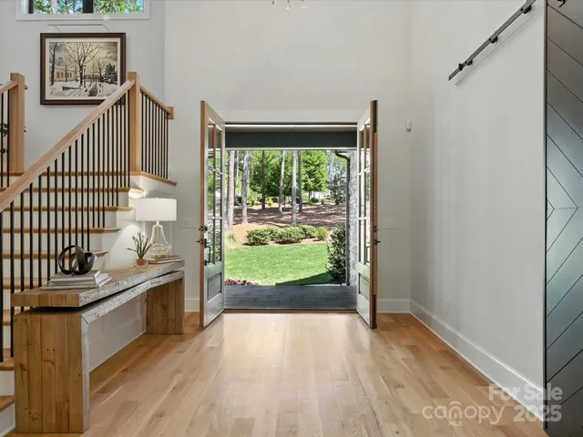 a view of a hallway with wooden floor and a fireplace