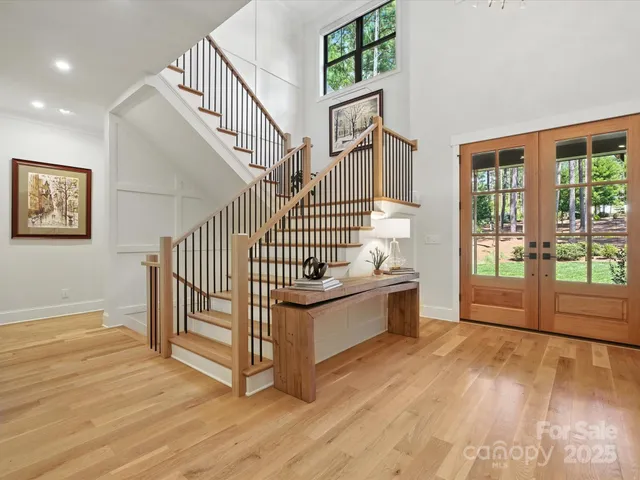 a view of a room with wooden floor and windows