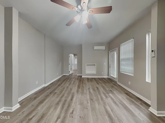 wooden floor in an empty room with a window