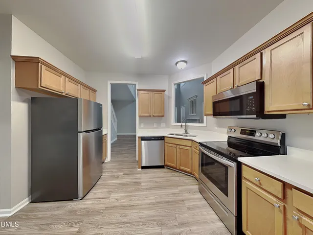 a kitchen with stainless steel appliances granite countertop a refrigerator stove and microwave