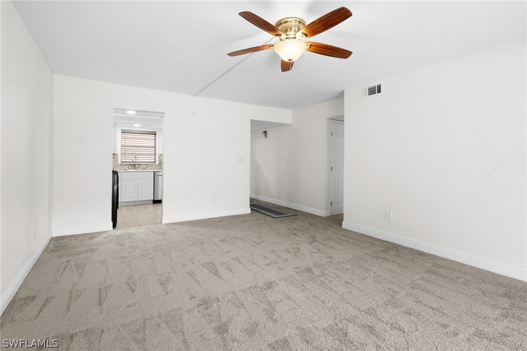 4608 Southeast 6th Avenue, Unit 1D Cape Coral, FL 33904 - Photo 14 of 49 a view of a big room with wooden floor and a ceiling fan