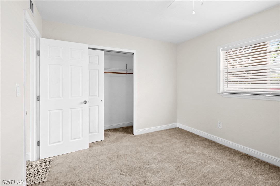 4608 Southeast 6th Avenue, Unit 1D Cape Coral, FL 33904 - Photo 27 of 49 an empty room with windows and closet