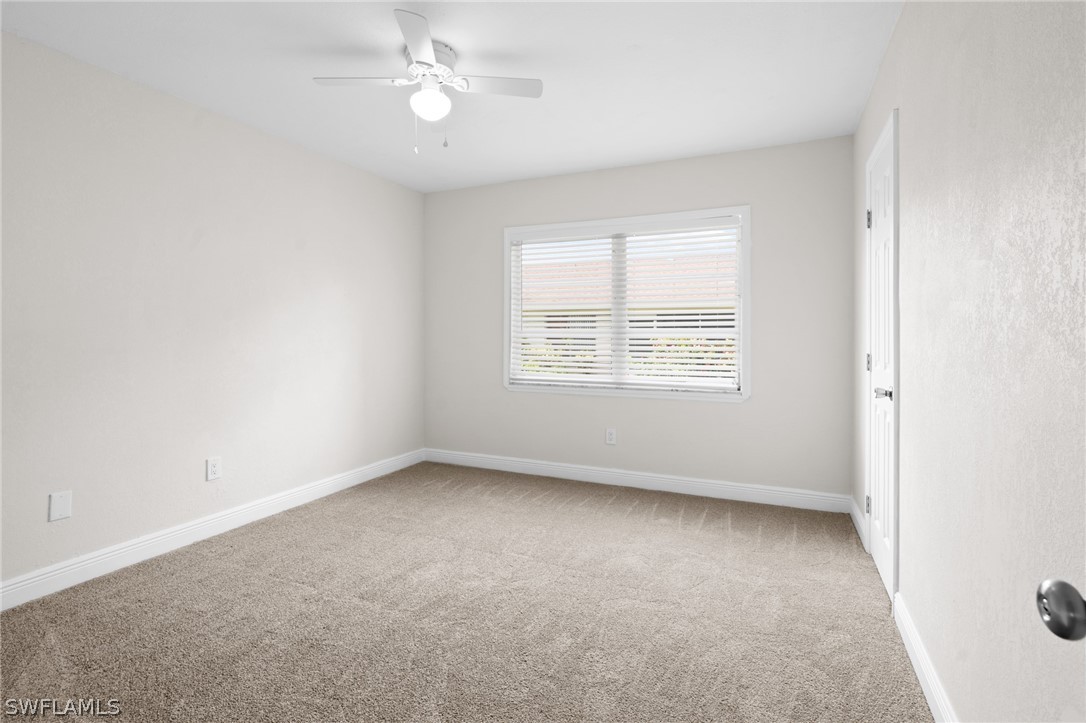 4608 Southeast 6th Avenue, Unit 1D Cape Coral, FL 33904 - Photo 34 of 49 an empty room with a window and ceiling fan