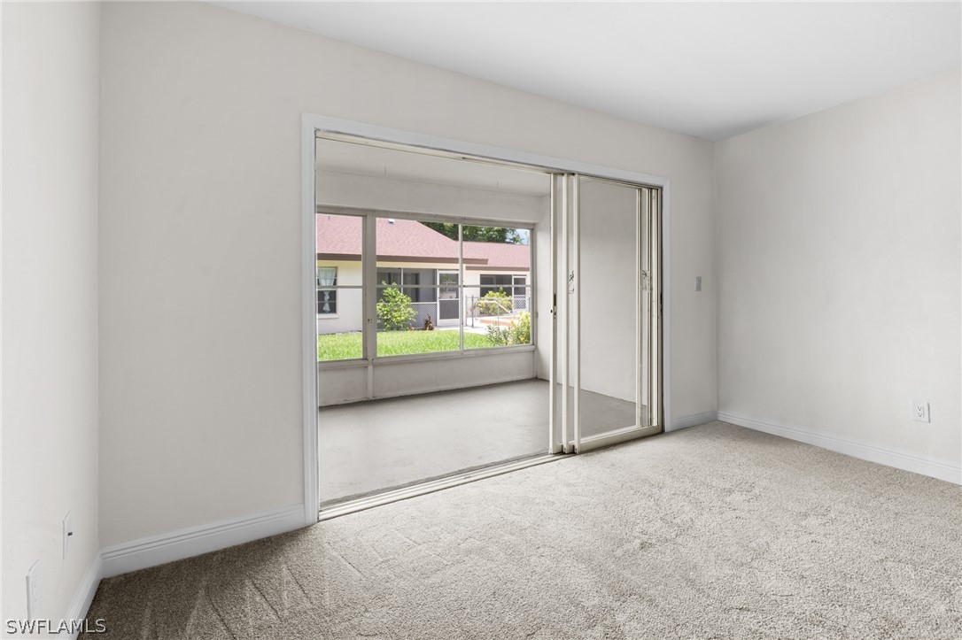 4608 Southeast 6th Avenue, Unit 1D Cape Coral, FL 33904 - Photo 40 of 49 an empty room with sliding door