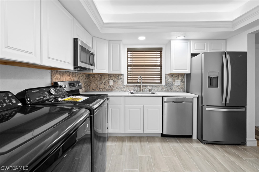 4608 Southeast 6th Avenue, Unit 1D Cape Coral, FL 33904 - Photo 8 of 49 a kitchen with a stove a sink and a refrigerator