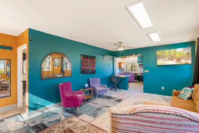 a bedroom with furniture and a large window