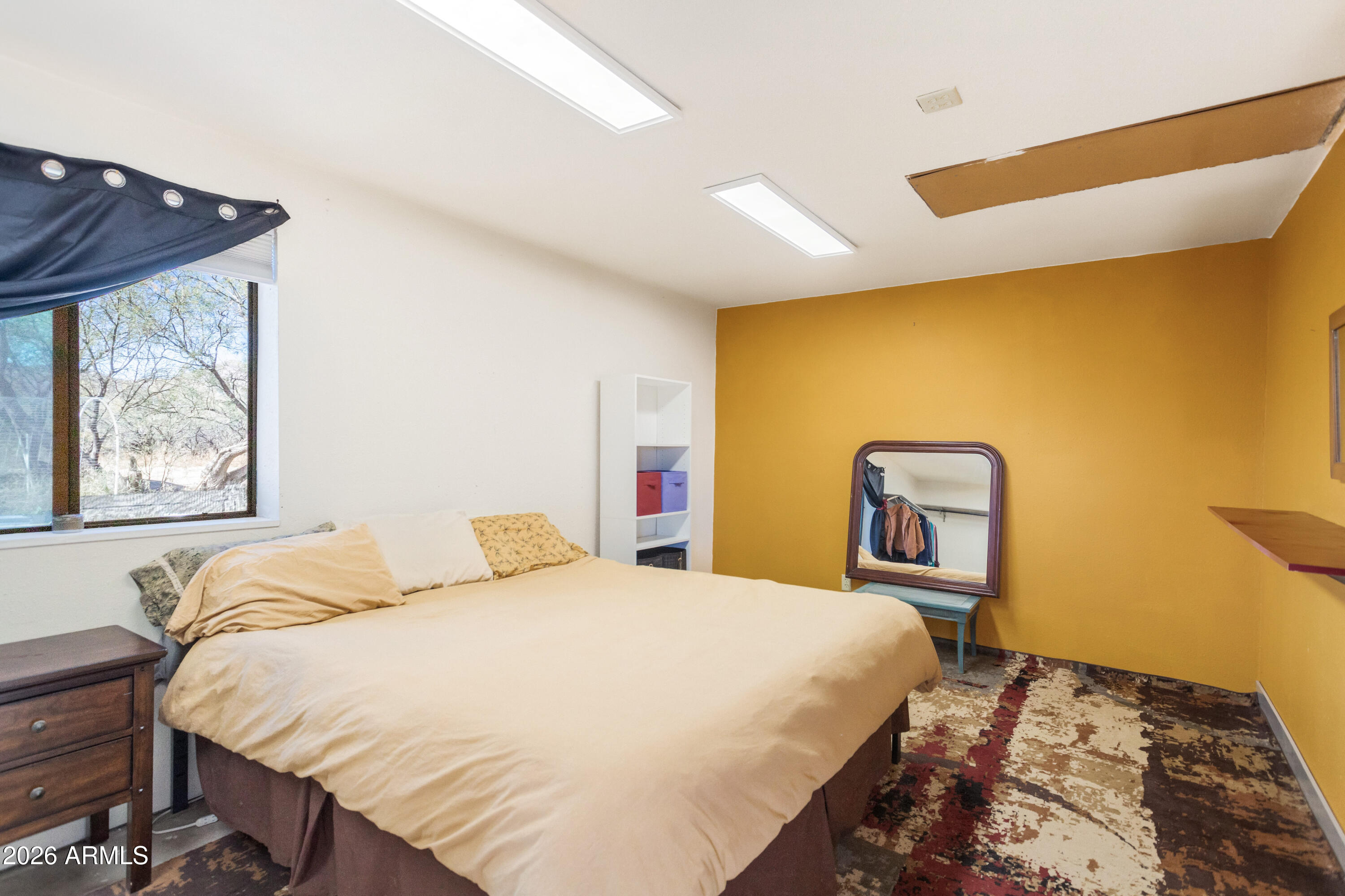 2271 North Sands Ranch Road Huachuca City, AZ 85616 - Photo 20 of 50 a bedroom with a bed and wooden floor