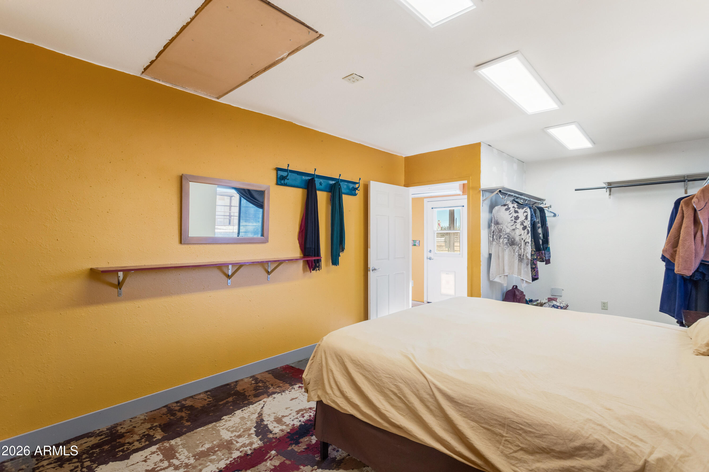 2271 North Sands Ranch Road Huachuca City, AZ 85616 - Photo 21 of 50 a bedroom with a bed and a painting on the wall
