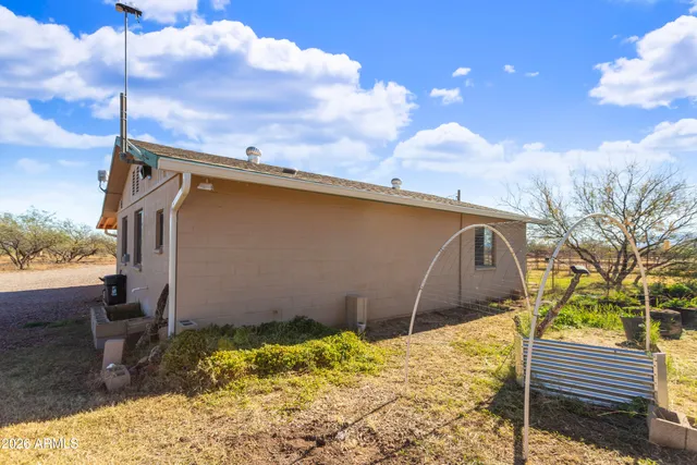 a front view of a house with basket ball court tables and chairs