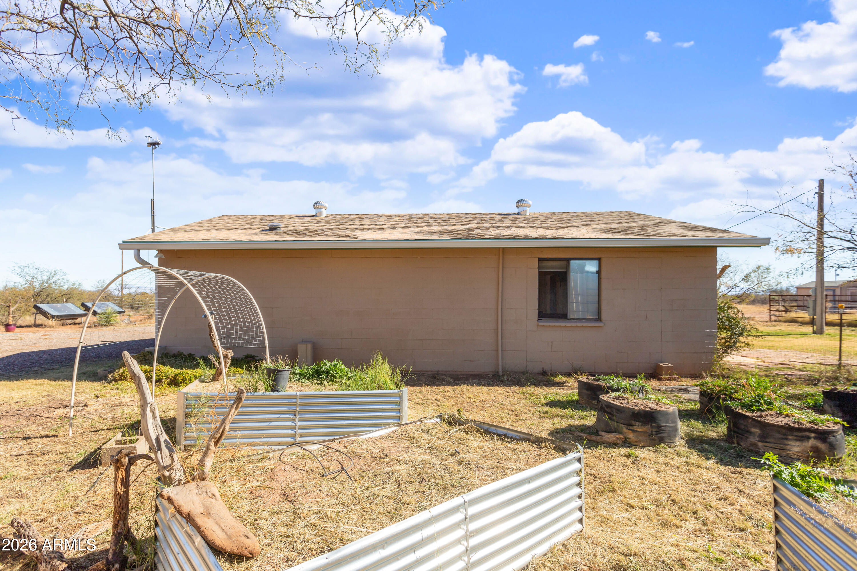 2271 North Sands Ranch Road Huachuca City, AZ 85616 - Photo 25 of 50 a front view of a house with basket ball court tables and chairs