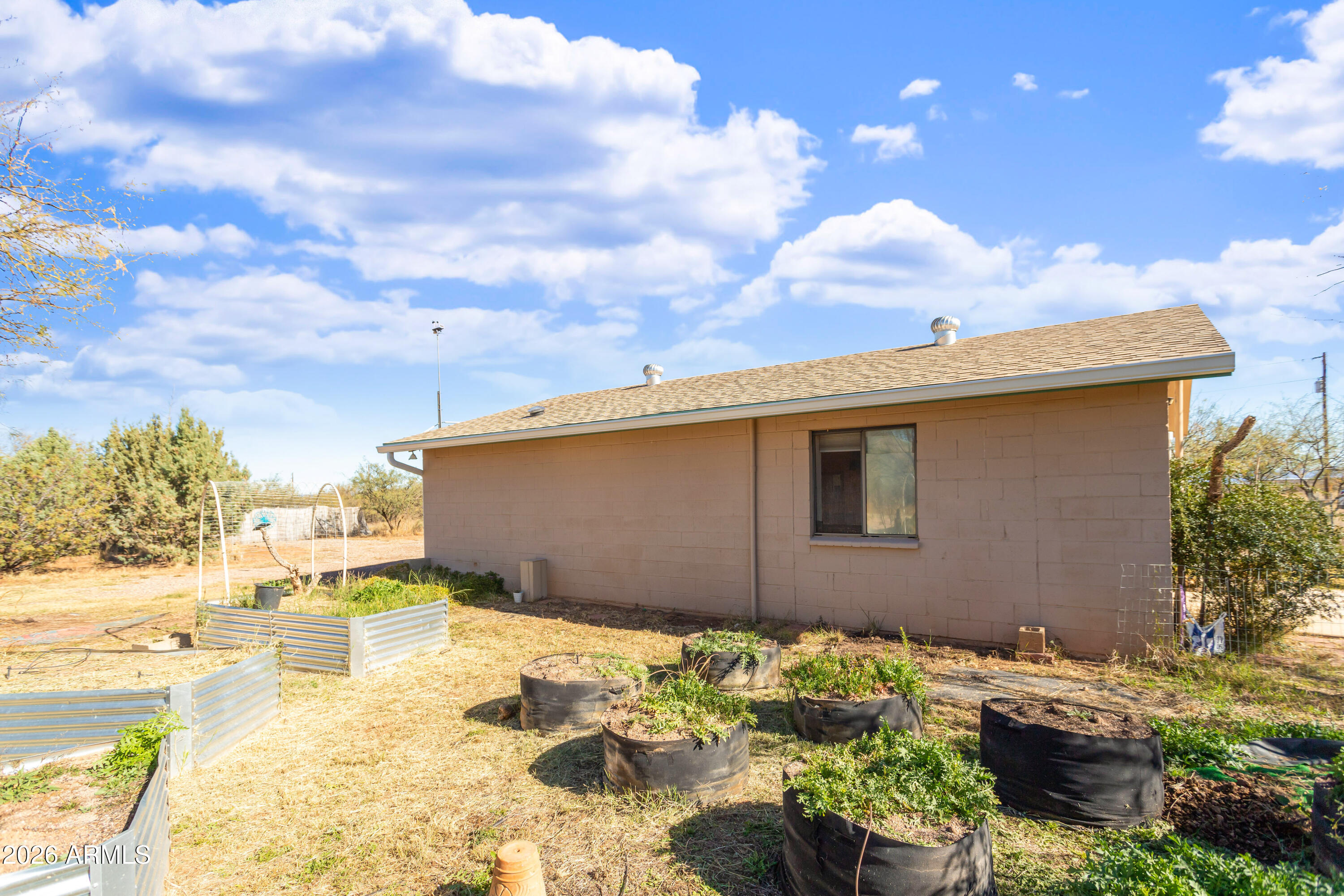 2271 North Sands Ranch Road Huachuca City, AZ 85616 - Photo 26 of 50 a backyard of a house with a yard and outdoor seating