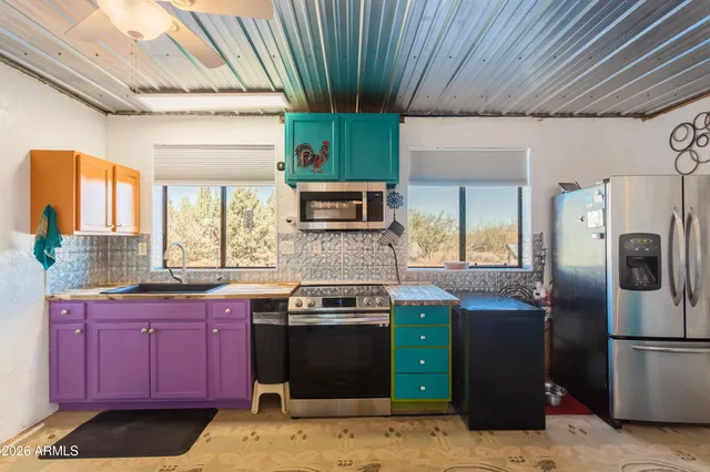 a kitchen with stainless steel appliances granite countertop a stove a sink dishwasher and a refrigerator