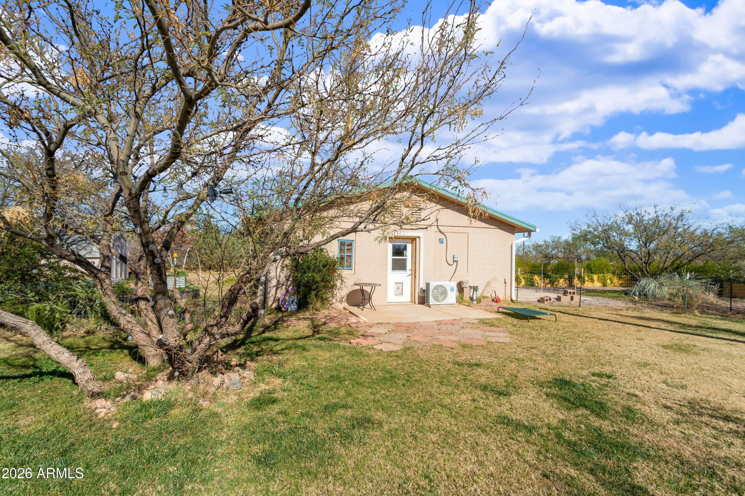 2271 North Sands Ranch Road Huachuca City, AZ 85616 - Photo 35 of 50 a view of a large white house with a large tree