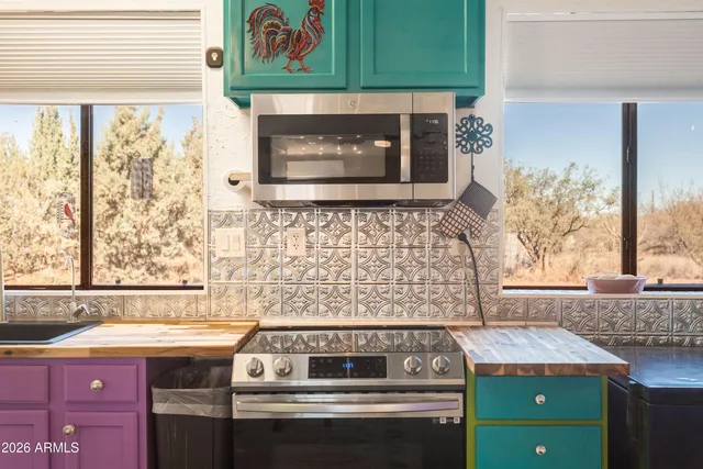 a stove top oven sitting inside of a kitchen