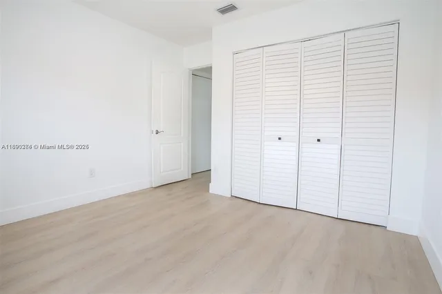 an empty room with wooden floor
