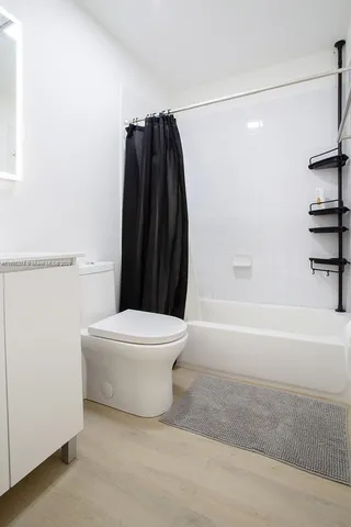 a bathroom with a toilet and a bathtub