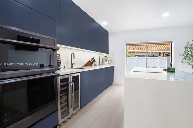 a kitchen with stainless steel appliances a stove a sink and a refrigerator