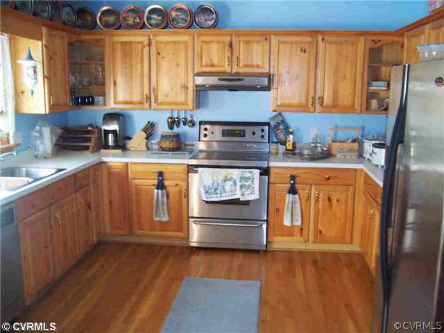2407 Fairground Road Maidens, VA 23102 - Photo 3 of 4 a kitchen with stainless steel appliances granite countertop a stove and a refrigerator