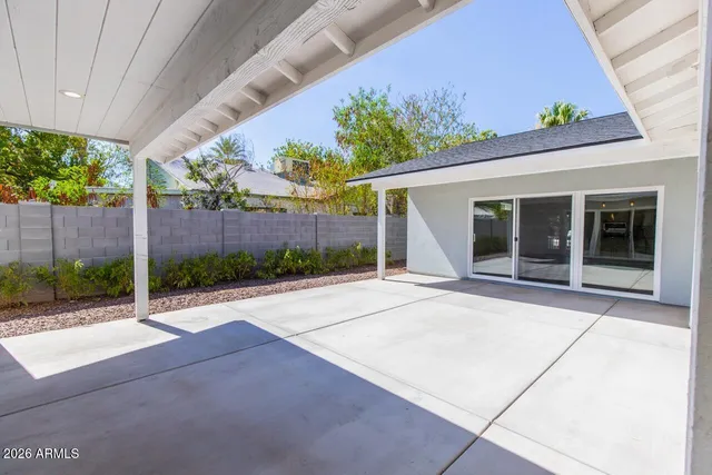 a porch with seating space and garden view