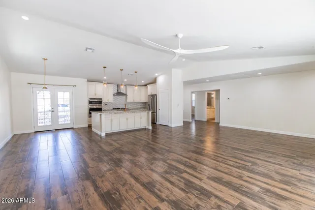 a view of a kitchen with a sink and a refrigerator