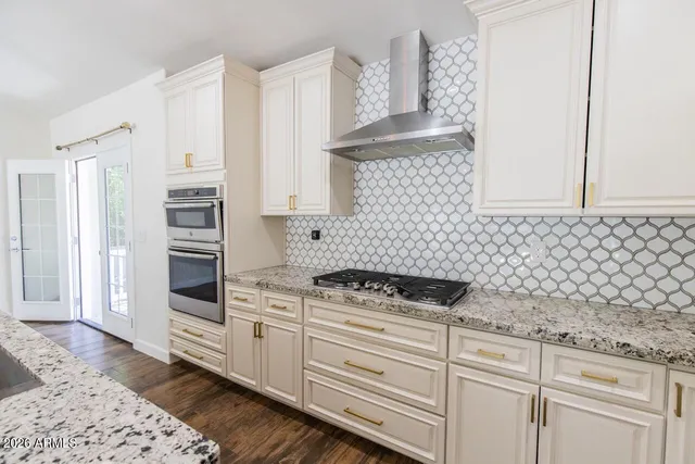 a kitchen with stainless steel appliances white cabinets and a stove