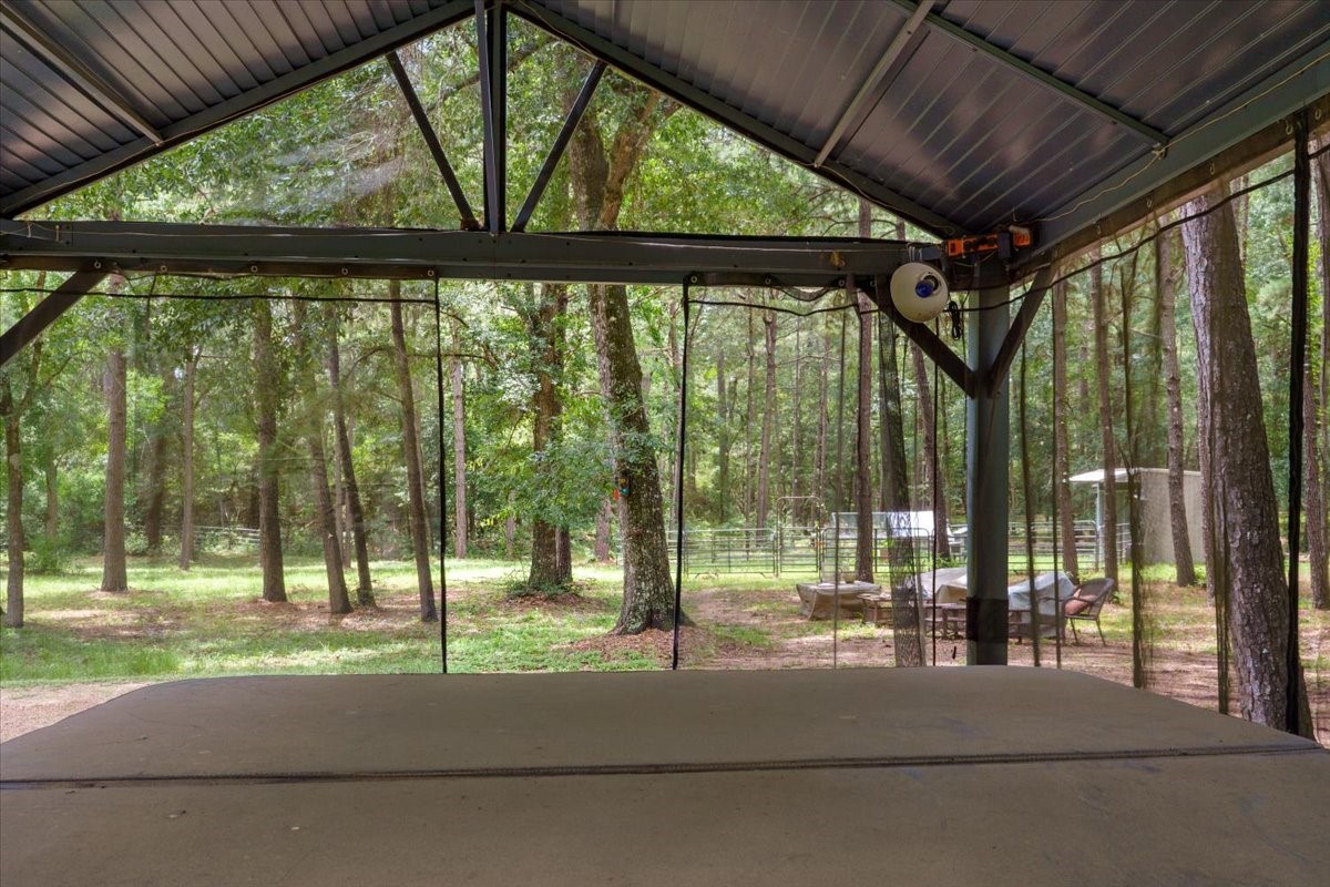 16375 Grand Flower Road Plantersville, TX 77363 - Photo 47 of 50 a view of yard with a car porch