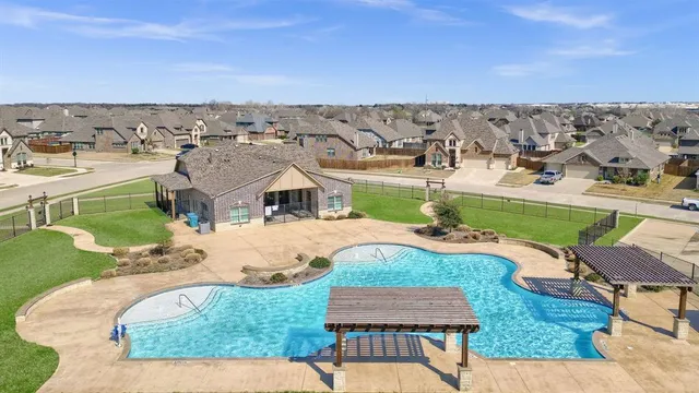 an aerial view of a house with yard swimming pool and outdoor seating