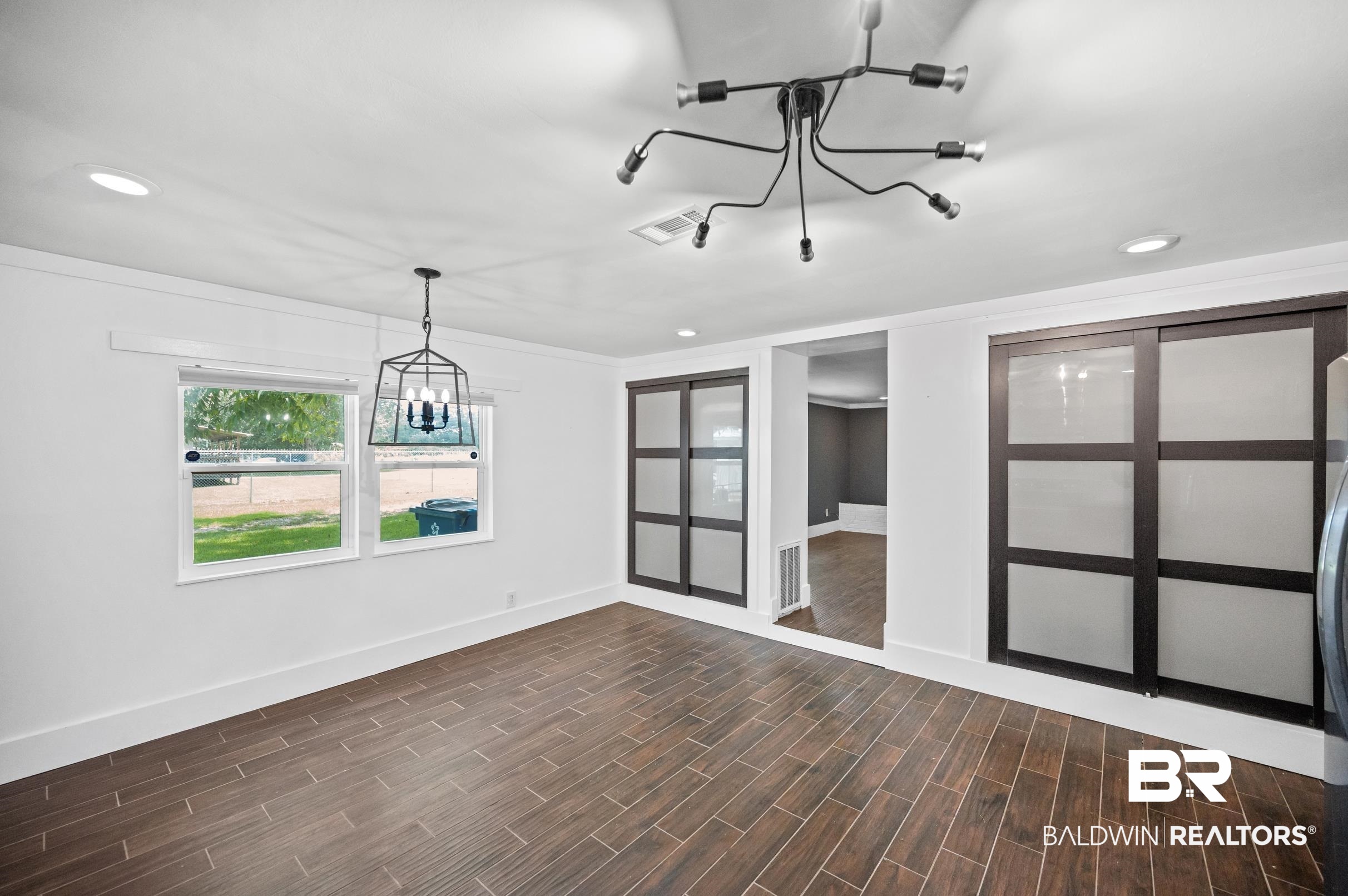 24663 Chestnut Street Elberta, AL 36530 - Photo 16 of 22 Spacious room featuring wood-finish tile flooring, recessed lighting, and white walls