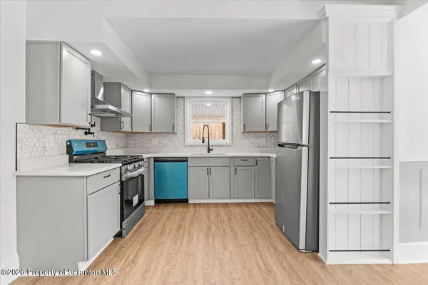a kitchen with a refrigerator sink and cabinets
