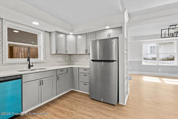 a kitchen with a refrigerator a sink and cabinets