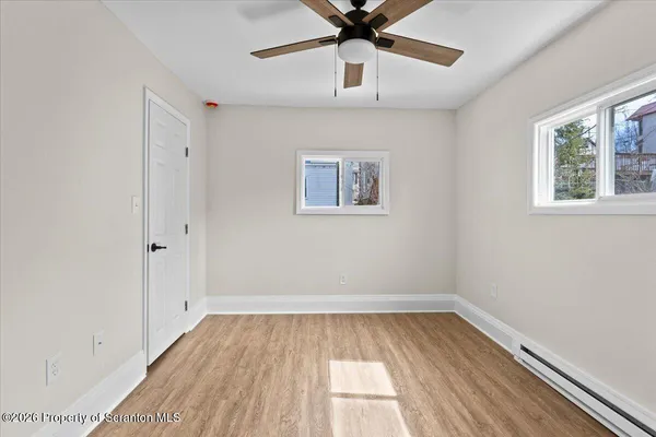 wooden floor in an empty room with a window