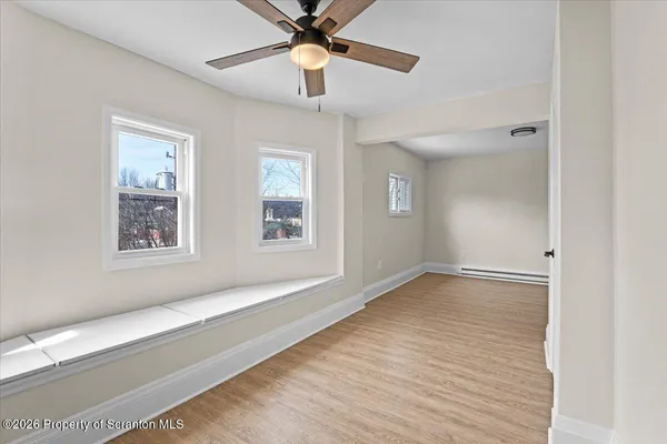 wooden floor in an empty room with a window