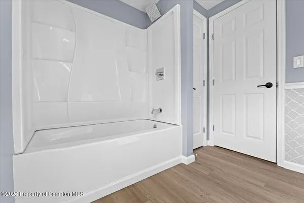 a bathroom with a bathtub and shower