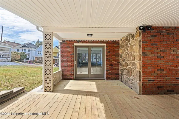 a view of a patio with wooden floor