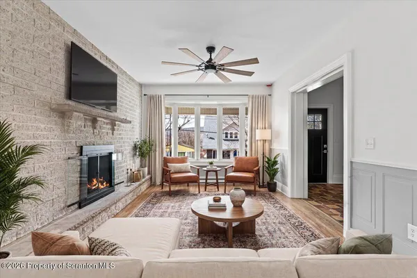 a living room with furniture a fireplace and a flat screen tv