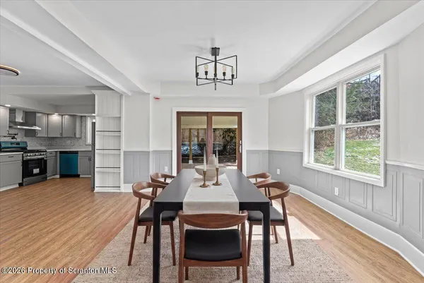 a view of a dining room with furniture window and wooden floor