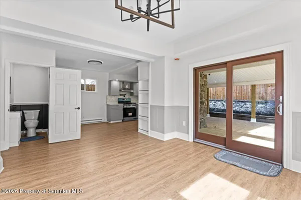 a view of empty room with wooden floor and windows