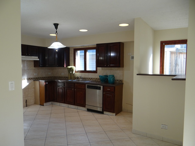 4212 North Ottawa Avenue Norridge, IL 60706 - Photo 2 of 7 a kitchen with stainless steel appliances granite countertop a stove a sink and a refrigerator
