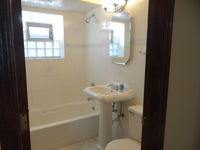 4212 North Ottawa Avenue Norridge, IL 60706 - Photo 7 of 7 a bathroom with a sink a toilet and shower
