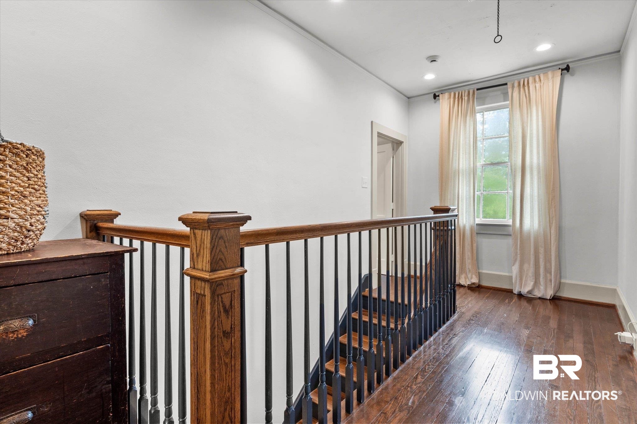 3863 Old Shell Road Mobile, AL 36608 - Photo 20 of 48 Hardwood flooring and a staircase featuring wood newel posts and handrails with black metal balusters