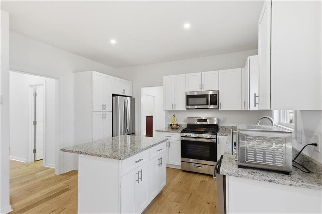 2769 Springfount Trail Northeast Lawrenceville, GA 30043 - Photo 12 of 56 a kitchen with granite countertop a refrigerator stove and sink