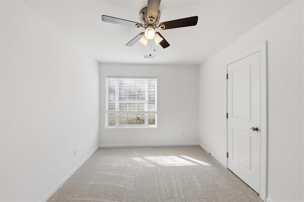 2769 Springfount Trail Northeast Lawrenceville, GA 30043 - Photo 22 of 56 an empty room with fan and windows