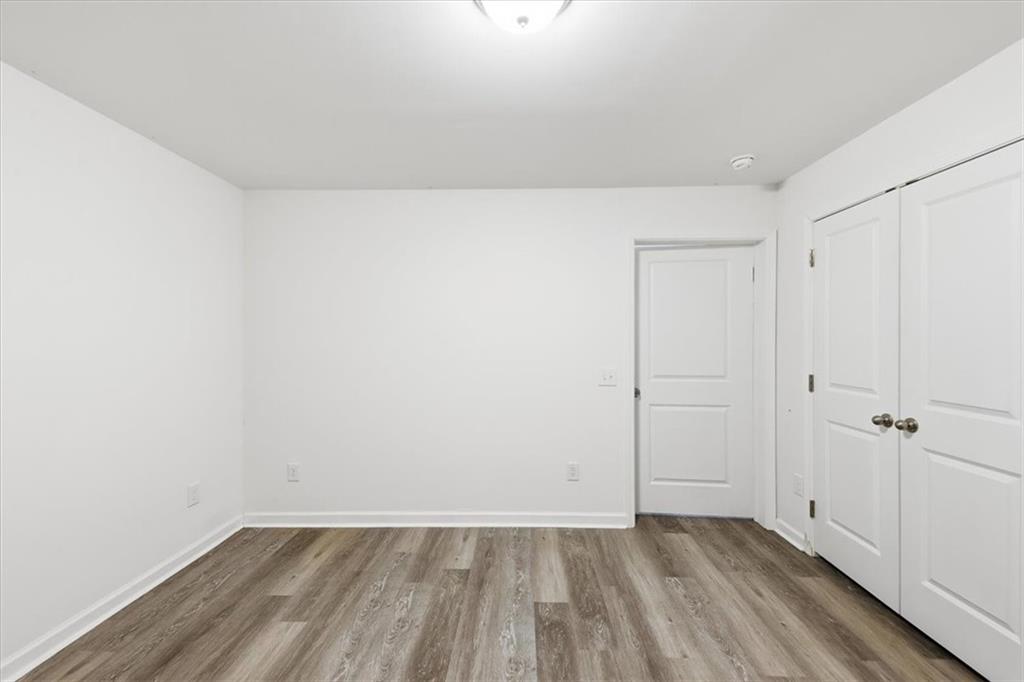 2769 Springfount Trail Northeast Lawrenceville, GA 30043 - Photo 42 of 56 an empty room with wooden floor and white walls