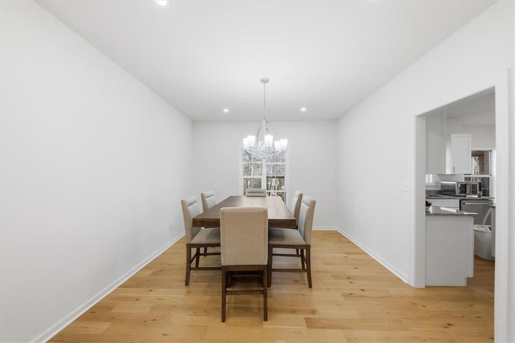 2769 Springfount Trail Northeast Lawrenceville, GA 30043 - Photo 8 of 56 a view of a dining room with furniture and wooden floor